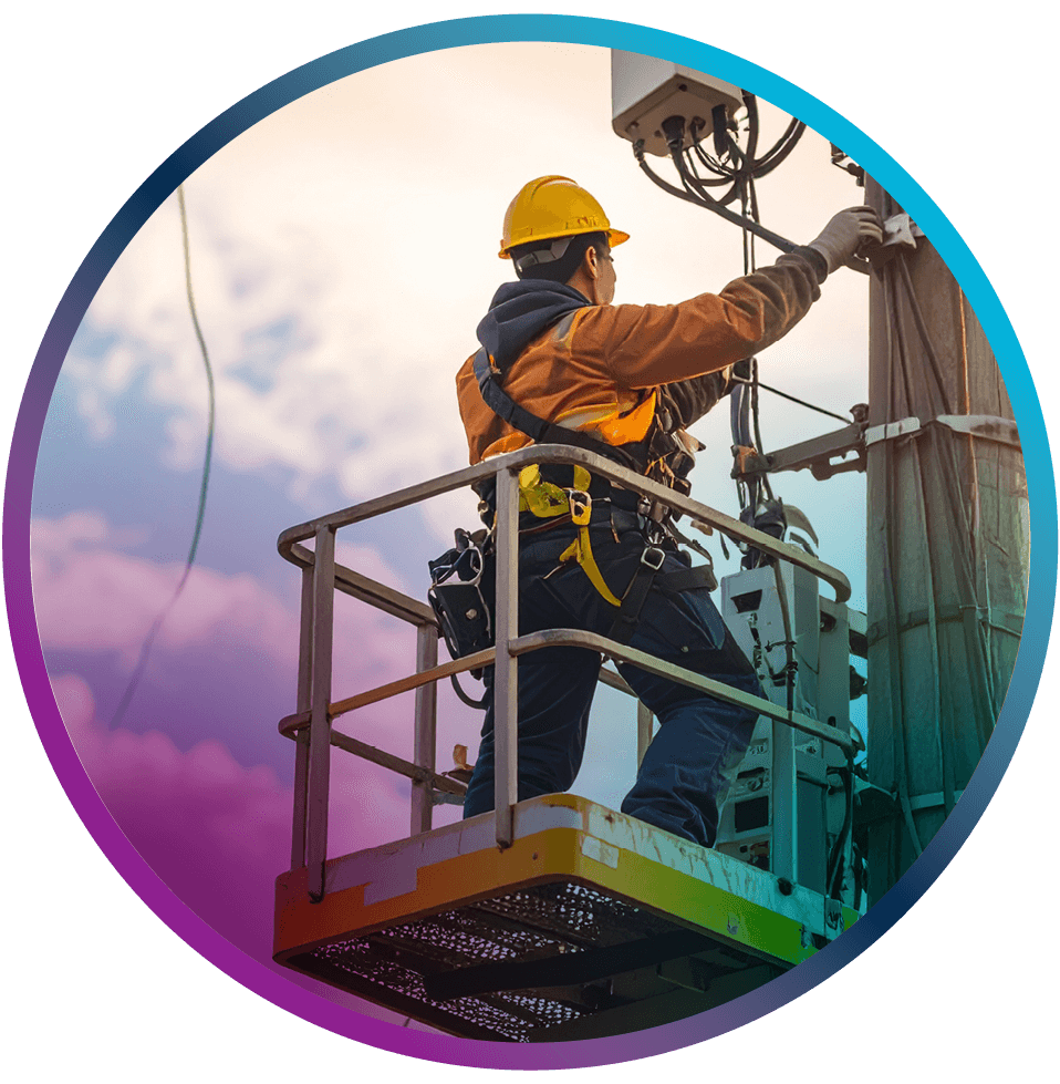 Technician on aerial lift installing network equipment on utility pole.
